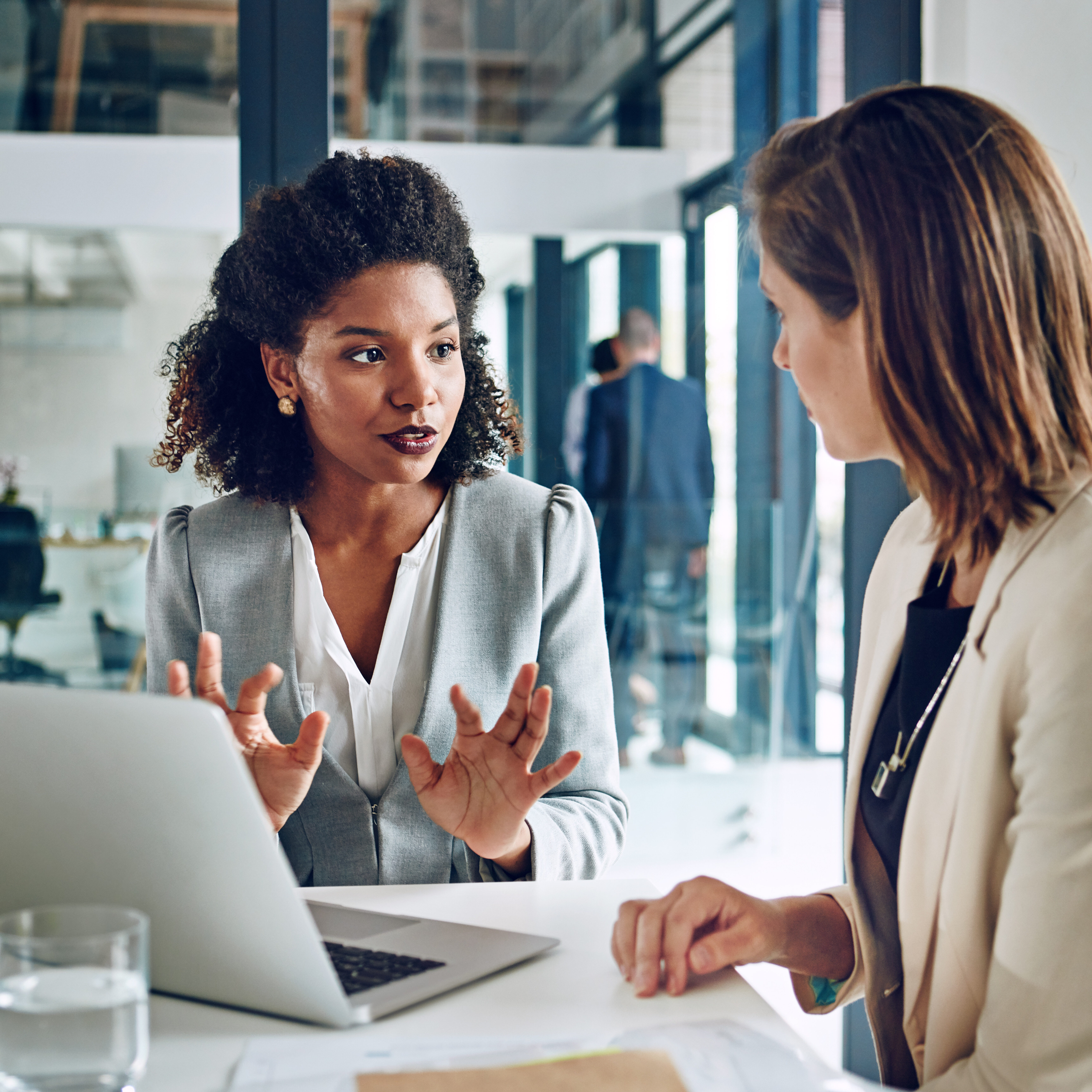 Laptop, meeting and business women in office for consulting, talking and discussion for online proposal. Corporate team, financial advisor and people on computer for planning, website and feedback.